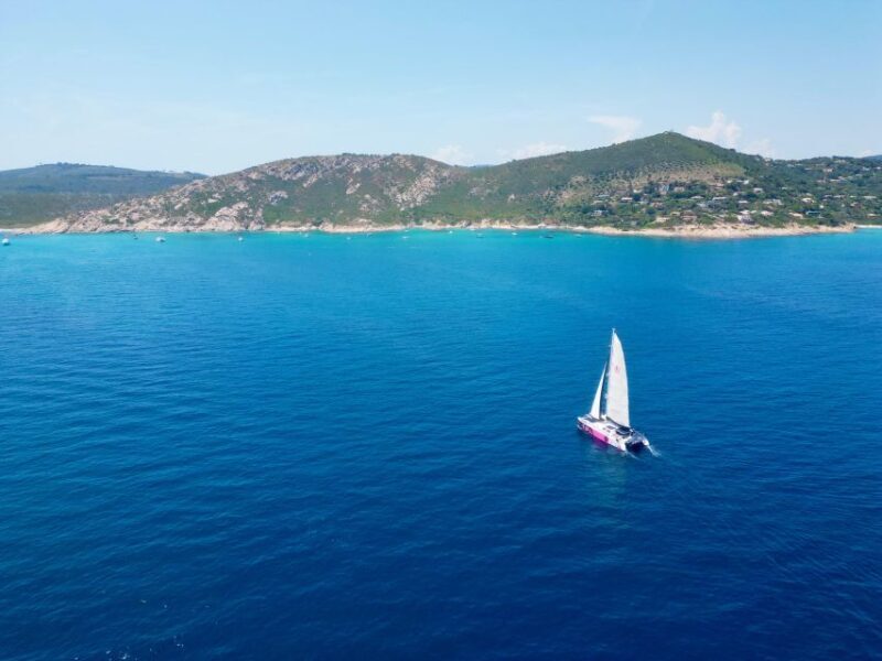 A luxury sailboat docked in a Greek island harbor.
